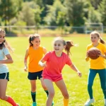 Engaged girls participating in Multi Sports Camps for Girls showcasing teamwork and excitement.